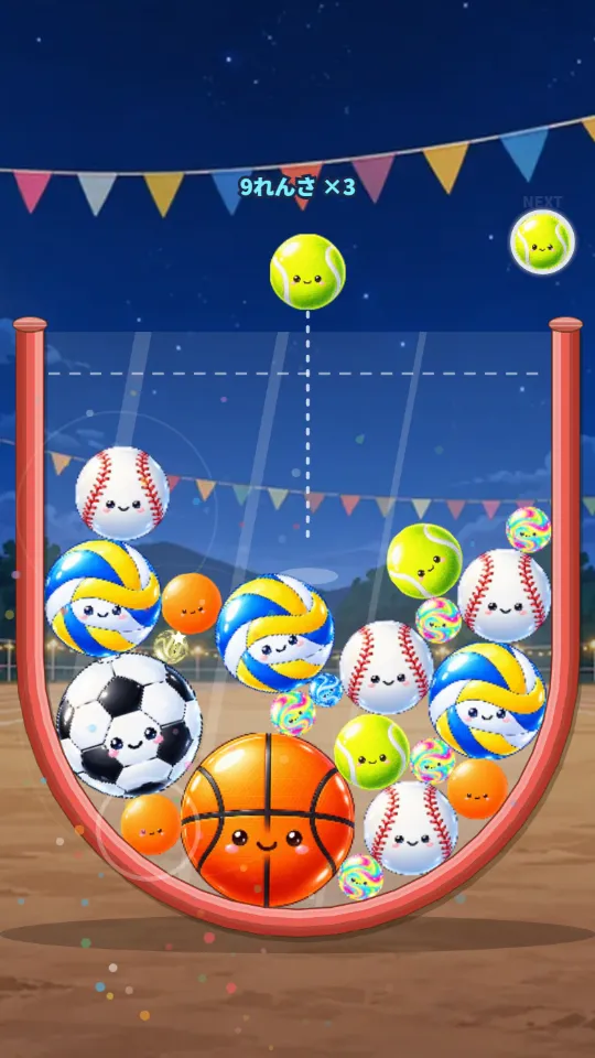 スマホの縦画面。夜のスタジアムで、赤いまんまるボウルの中に顔のついたバスケットボール・サッカーボール・バレーボール・野球ボール・テニスボールなどがぎゅうぎゅうにつまっている。上に次に落とすテニスボールと点線のねらい線、「9れんさ ×3」の文字