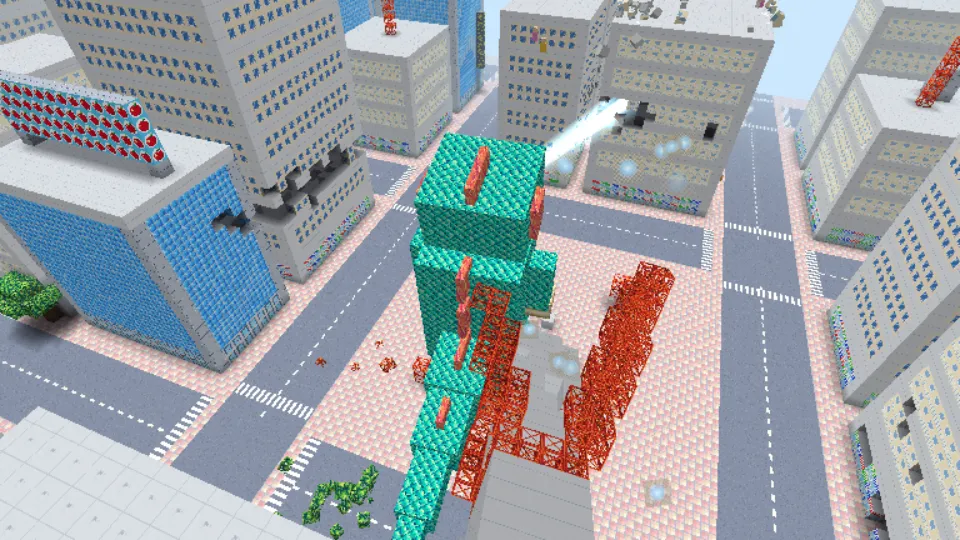 パソコンの横画面で、怪獣がビル街をこわし、ビルのブロックが飛び散っている
